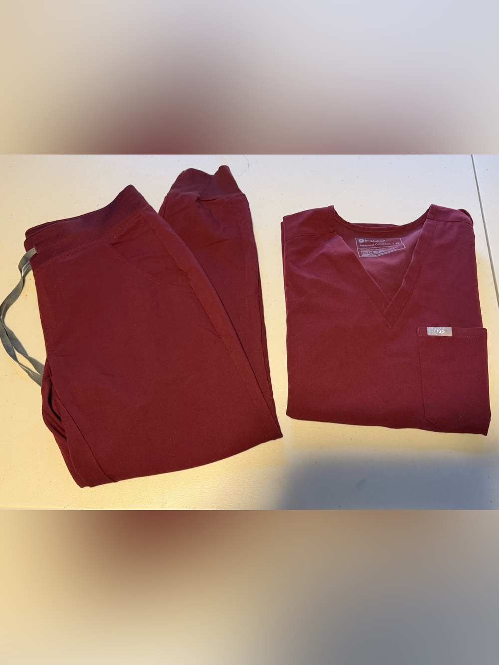 Women’s Figs Burgundy jogger scrub pants and one pocket scrub top